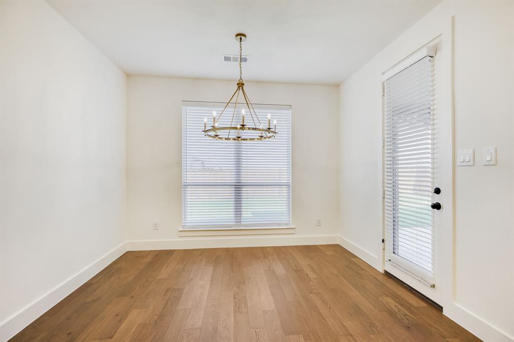 4314 Haley Way Oak Point, TX 75068 - Photo 6 of 28 Spacious room featuring wood-finish flooring, a contemporary chandelier, a large window with blinds, and a glass-paneled exterior door