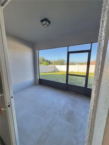 a view of an empty room with a floor to ceiling window