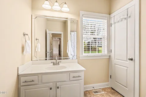 a bathroom with a sink a vanity and a mirror