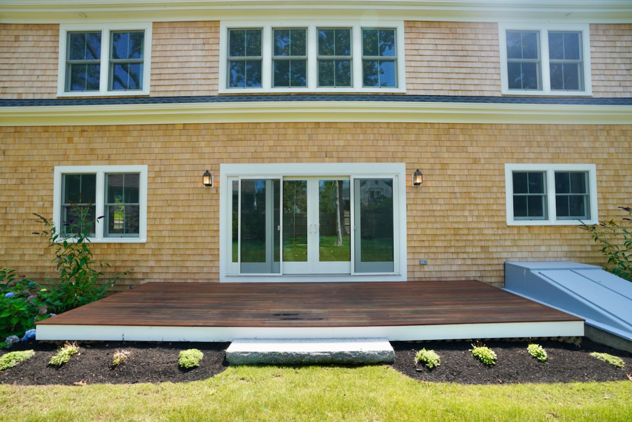 5 Ogden Lane Edgartown, MA 02539 - Photo 20 of 22 a wooden bench sitting in front of a house