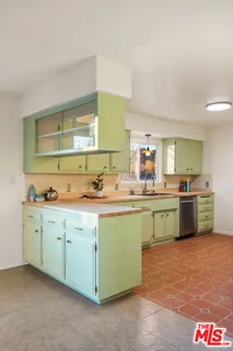 a view of a livingroom with a fireplace and window