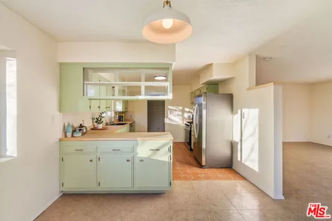 a view of a livingroom with furniture and a window