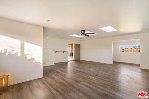 a front view of a house with a garden and yard