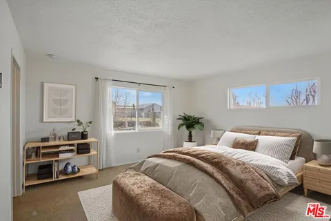 a view of an empty room with cabinet and a bathroom