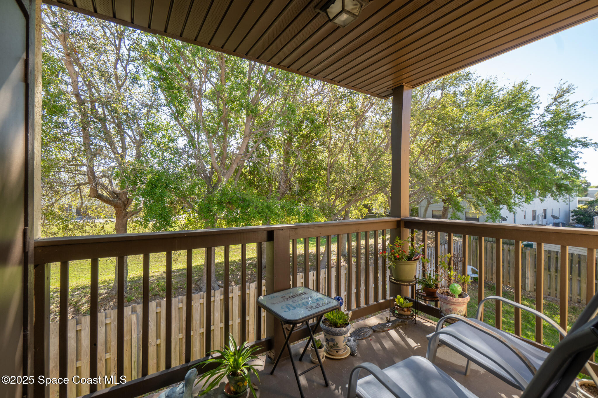 5610 North Banana River Boulevard, Unit 65 Cocoa Beach, FL 32931 - Photo 1 of 24 a view of a two chairs in the deck