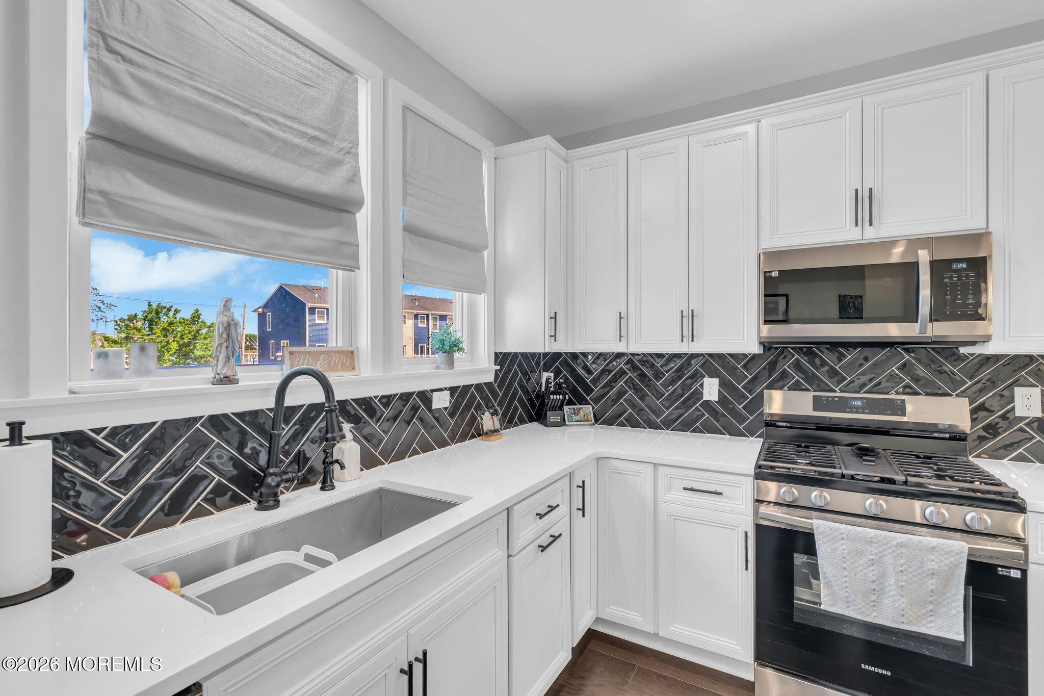 12 Raritan Boulevard Keyport, NJ 07735 - Photo 15 of 41 a kitchen with stainless steel appliances granite countertop a sink and a stove