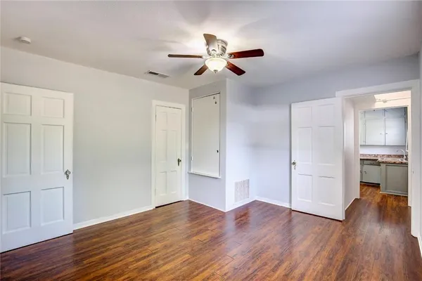 a view of empty room with wooden floor
