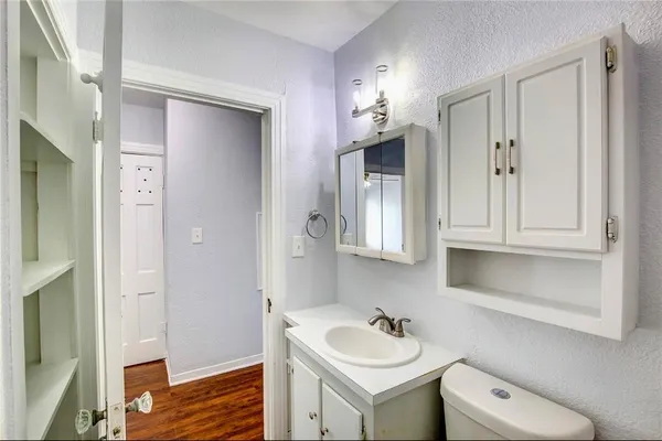 a bathroom with a toilet sink and mirror