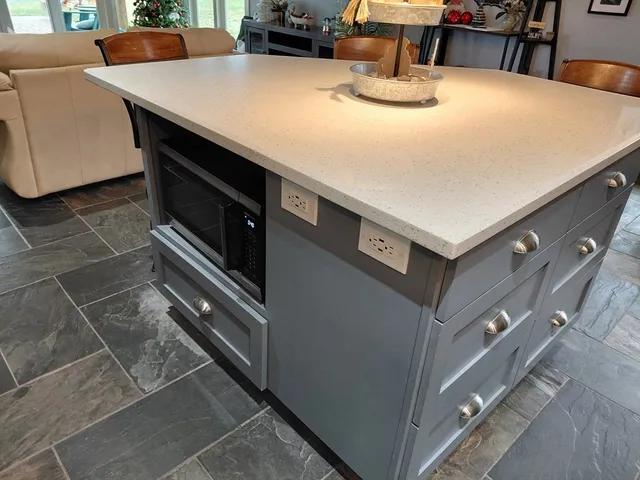 a kitchen with stainless steel appliances and white cabinets