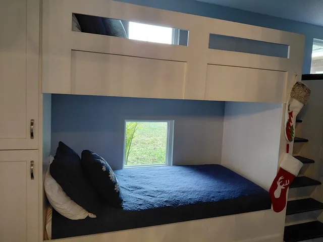 a bedroom with a bed and a window