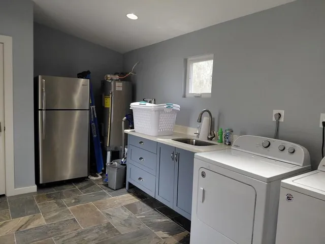 a kitchen with a refrigerator and cabinets