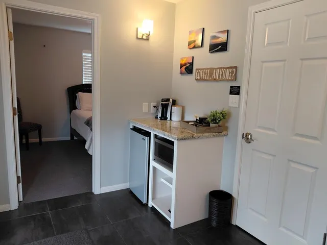a white toilet sitting next to a bathroom sink and a window
