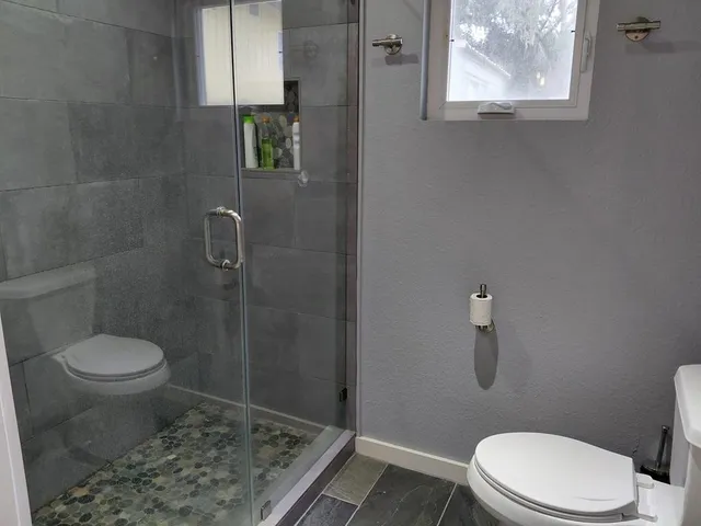 a bedroom with a bed and a flat tv screen on a dresser