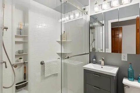 a spacious bedroom with a bed and a large window