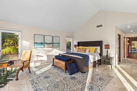 a living room with furniture and a book shelf