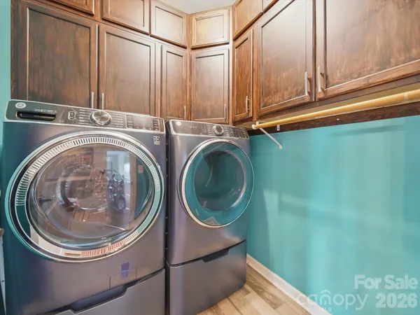 a utility room with sink dryer and washer