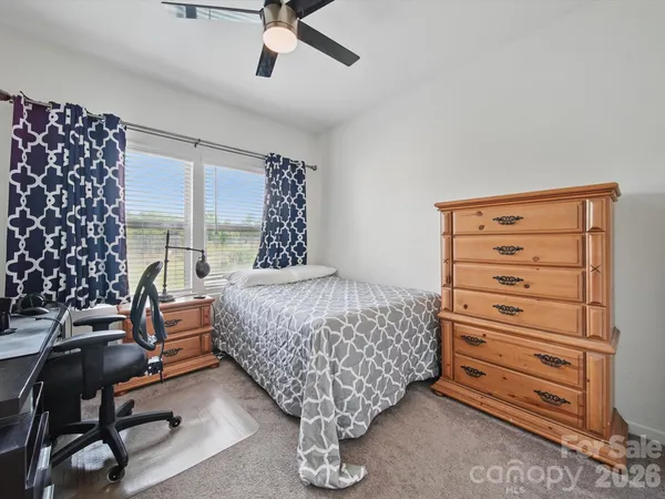 a bed sitting in a room next to a window