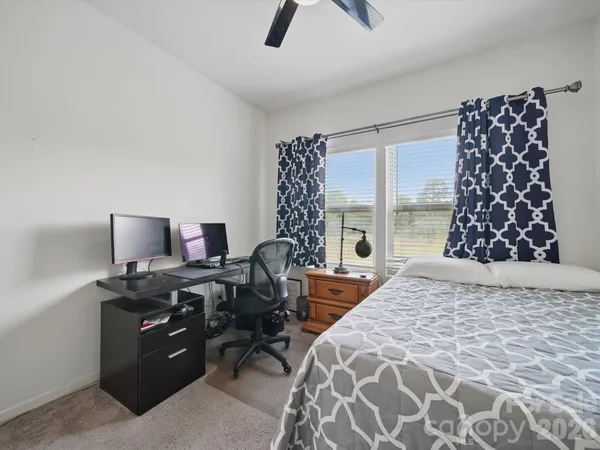 a bedroom with a bed and a chair