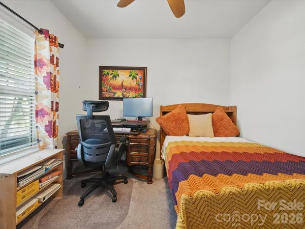 a bedroom with a bed and chair