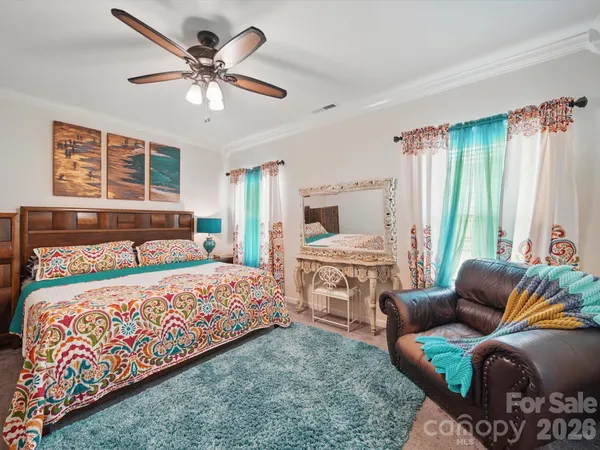 a bedroom with a bed couch and window