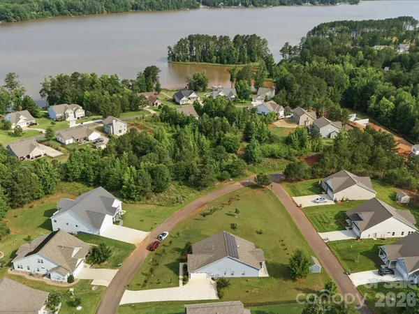 an aerial view of a house with a lake view