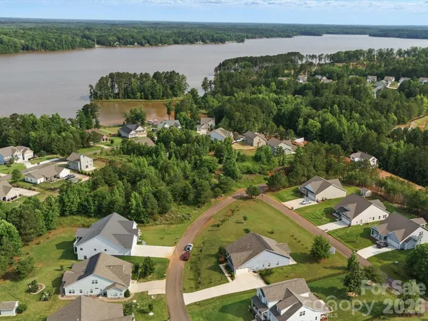 an aerial view of a house with a lake view