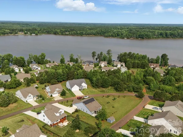 an aerial view of a house with a lake view