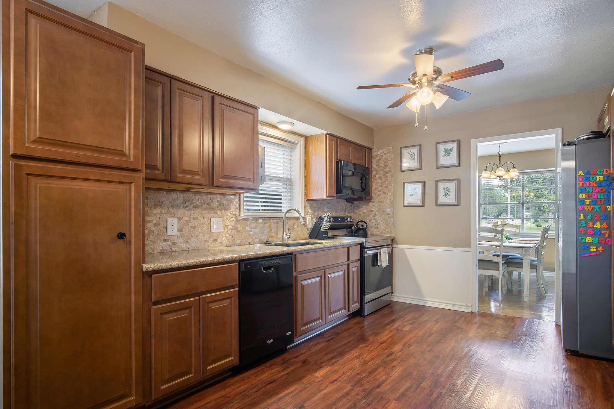 706 Yale Lane Deer Park, TX 77536 - Photo 12 of 43 a kitchen with stainless steel appliances granite countertop cabinets and wooden floor