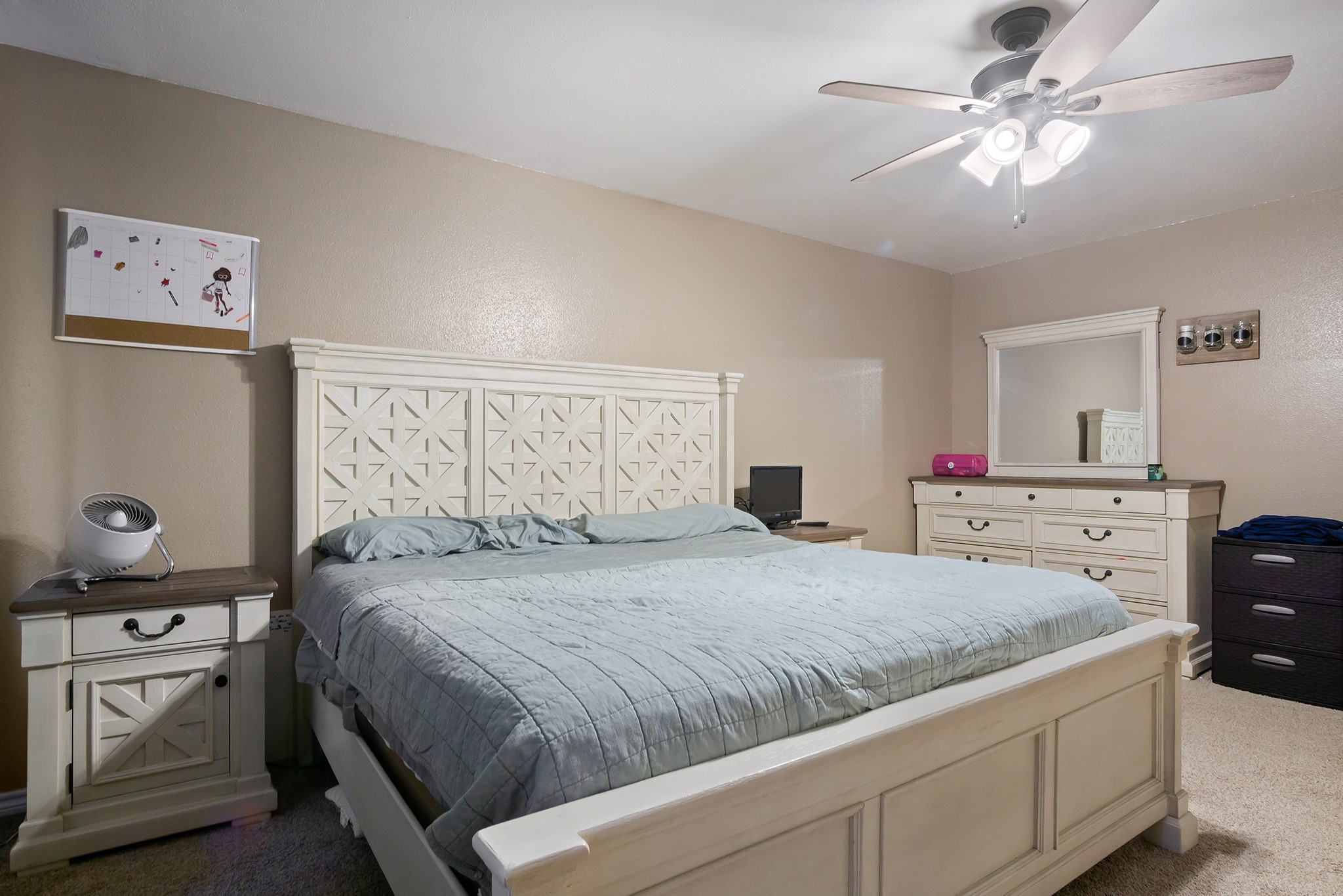 706 Yale Lane Deer Park, TX 77536 - Photo 25 of 43 a bedroom with a bed and a chandelier