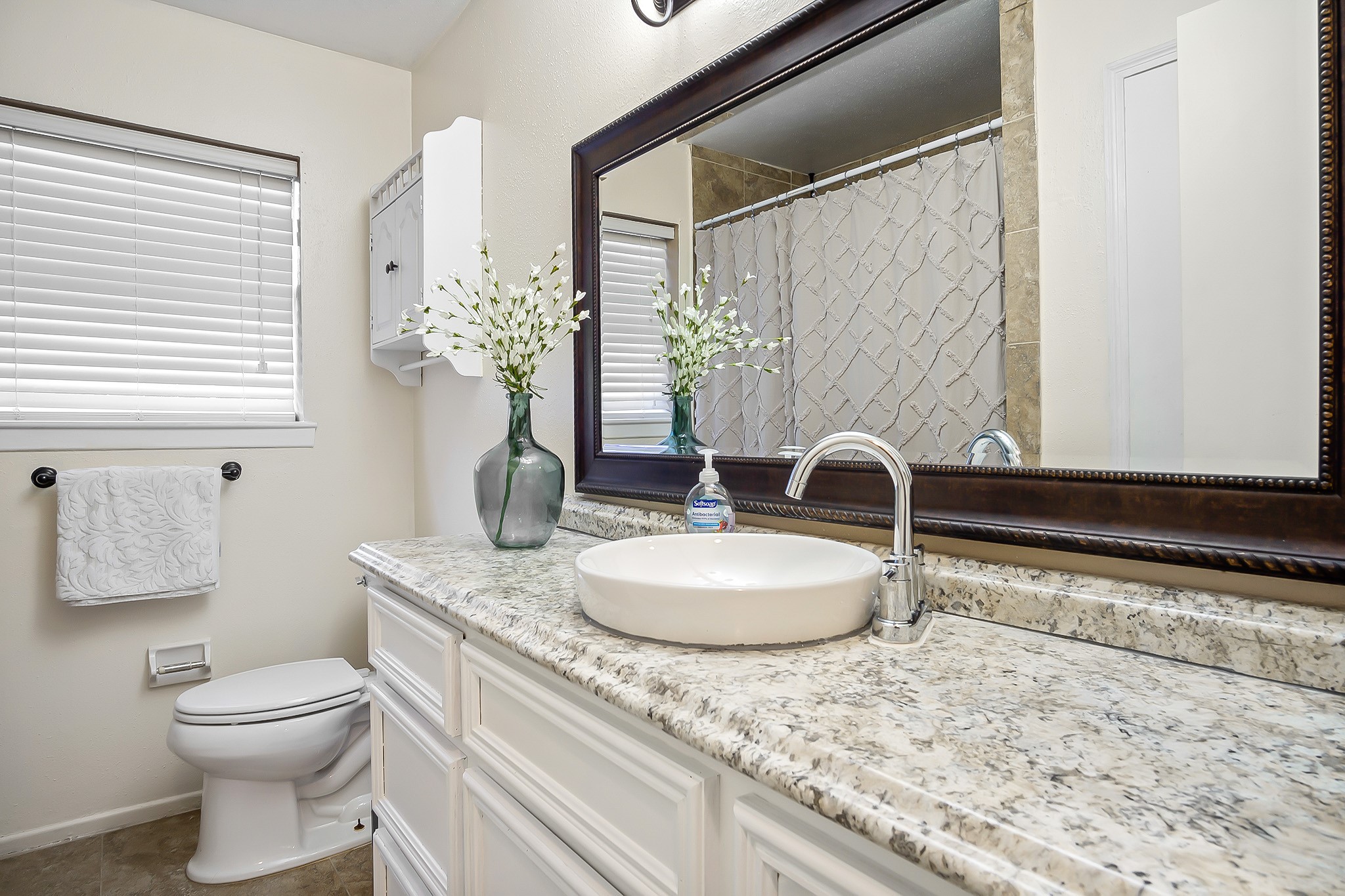 706 Yale Lane Deer Park, TX 77536 - Photo 27 of 43 a bathroom with a granite countertop sink a toilet and a mirror