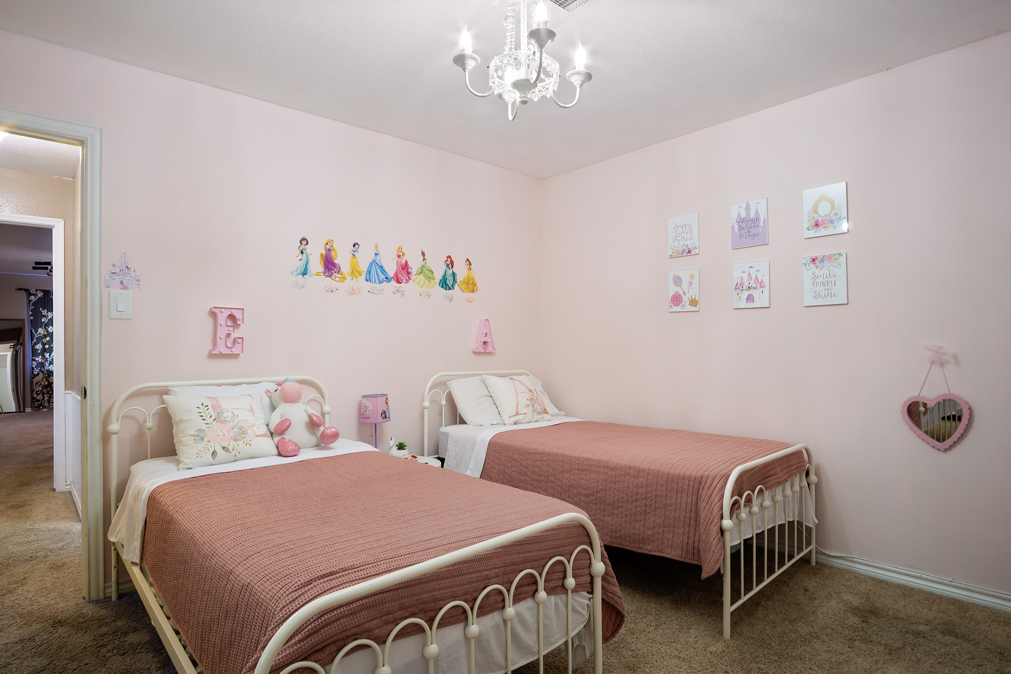 706 Yale Lane Deer Park, TX 77536 - Photo 29 of 43 a bedroom with two beds and a chandelier