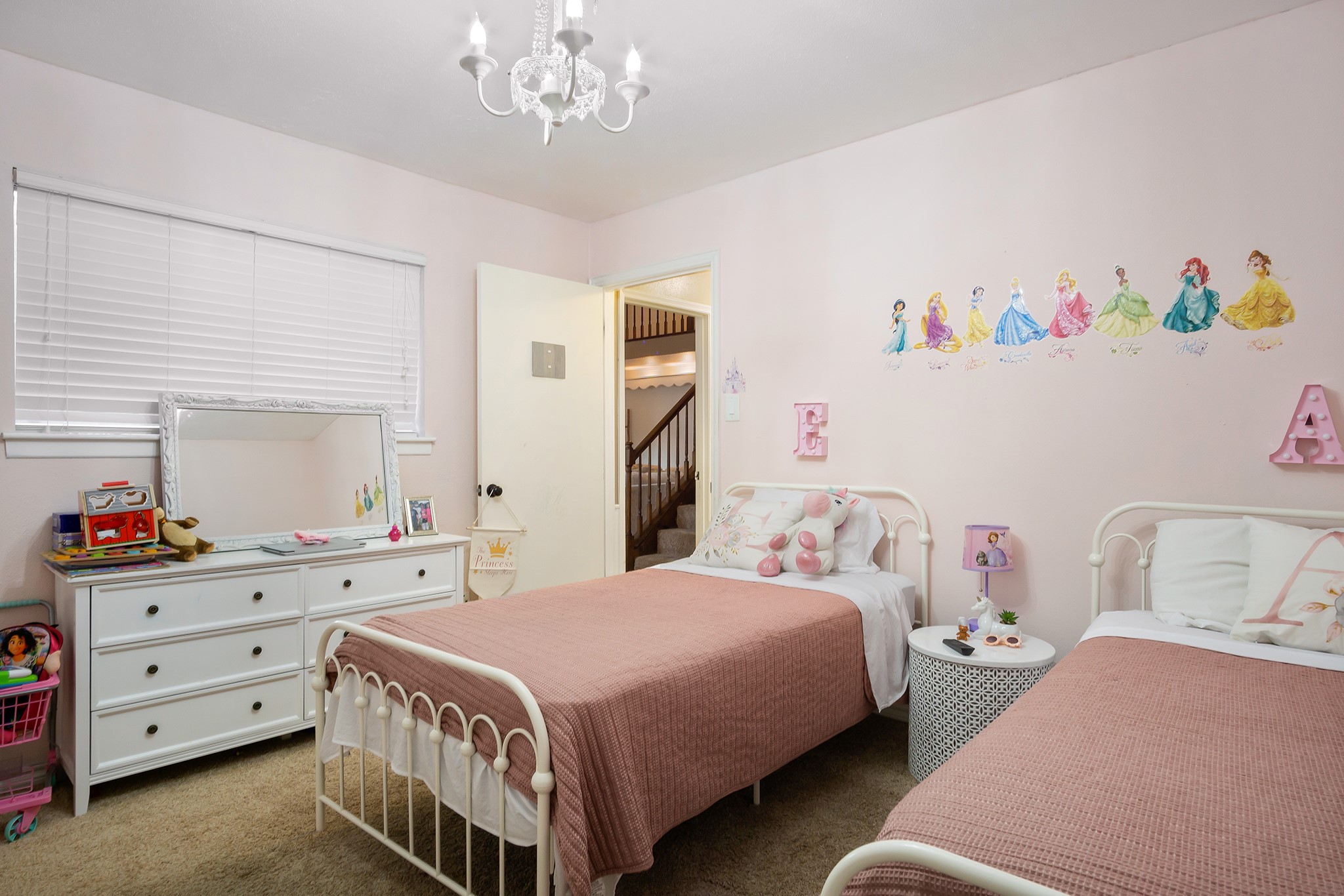 706 Yale Lane Deer Park, TX 77536 - Photo 30 of 43 a bedroom with a bed and a chandelier