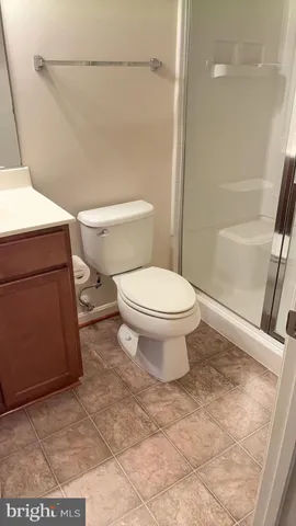 a white toilet sitting next to a bathroom sink