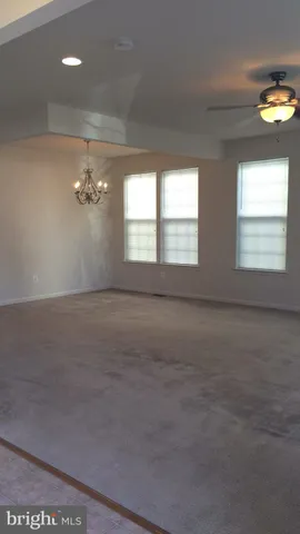 an empty room with a empty space and windows