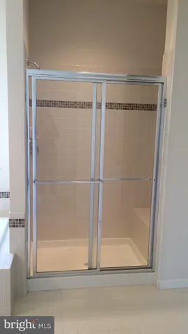 a bathroom with a glass shower door