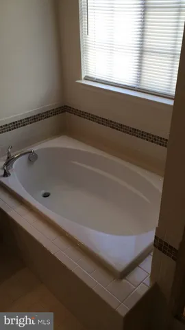 a bath tub sitting next to a window