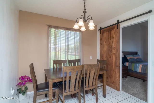 a view of a dining room with furniture and chandelier