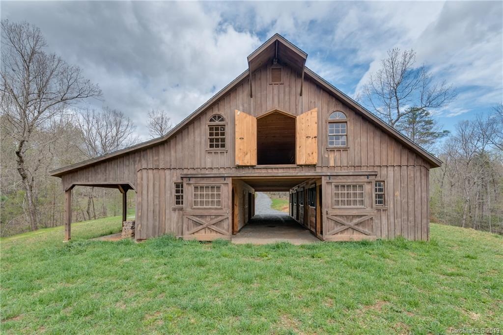 0 Sloping Meadow Mill Spring, NC 28756 - Photo 14 of 26 a front view of a house with a garden and yard