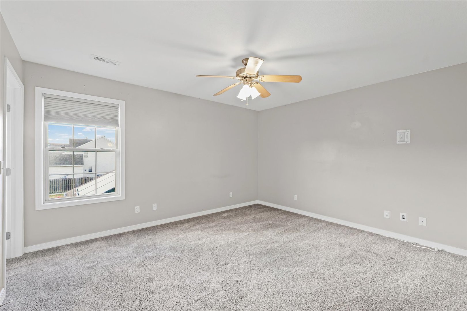 1424 Bluegrass Lane Champaign, IL 61822 - Photo 14 of 29 an empty room with windows and chandelier fan