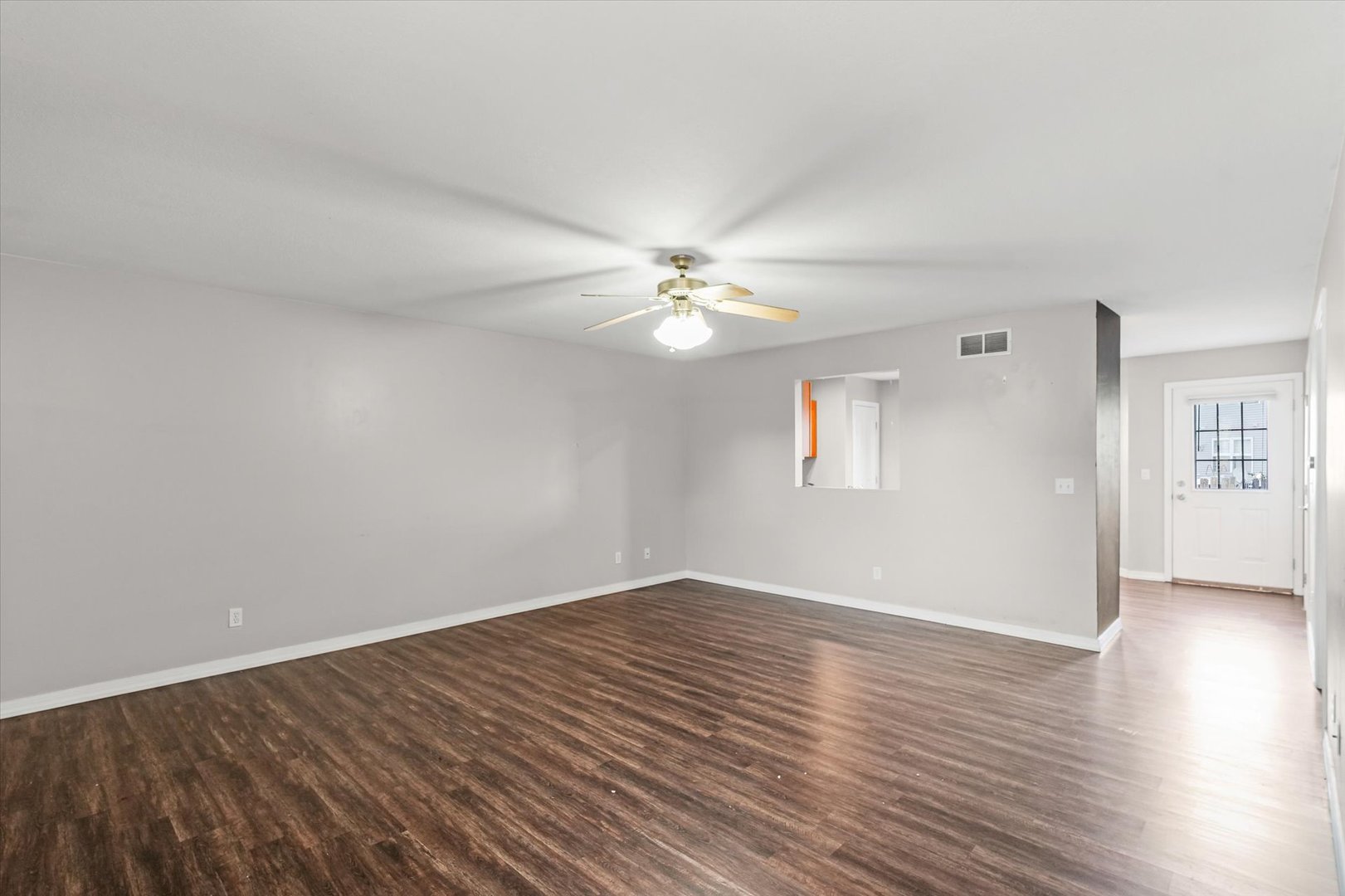 1424 Bluegrass Lane Champaign, IL 61822 - Photo 4 of 29 a view of a room with wooden floor and a ceiling fan