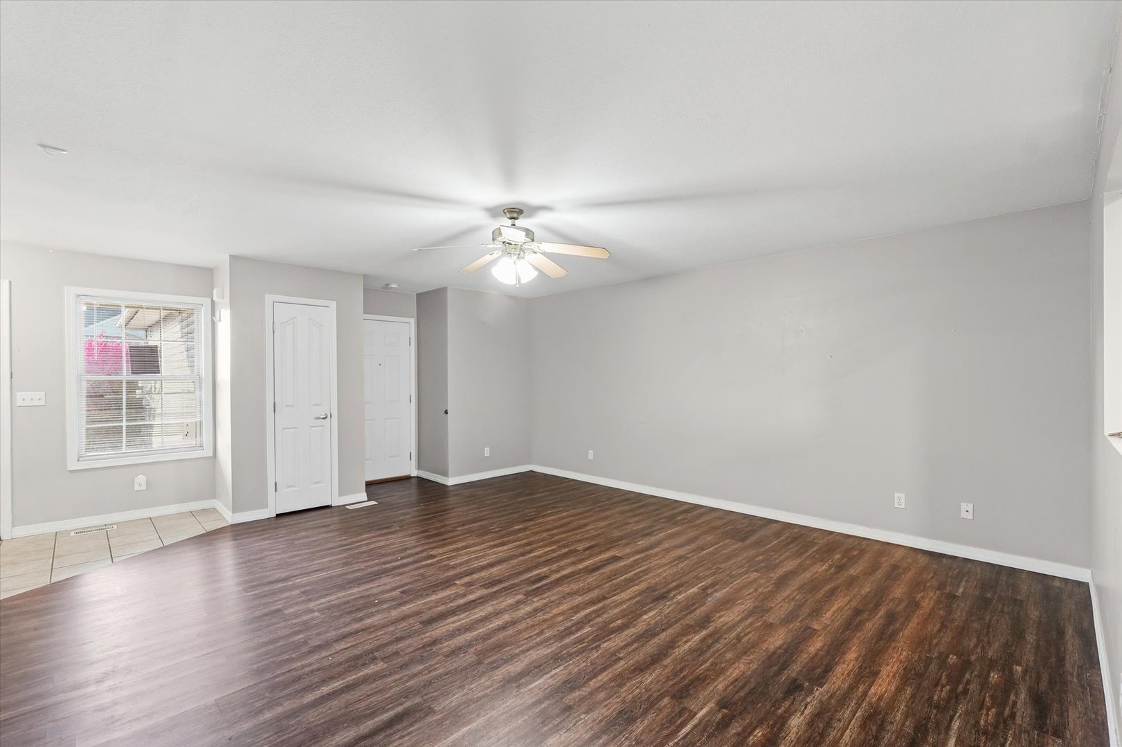 1424 Bluegrass Lane Champaign, IL 61822 - Photo 5 of 29 a view of an empty room with wooden floor and a window