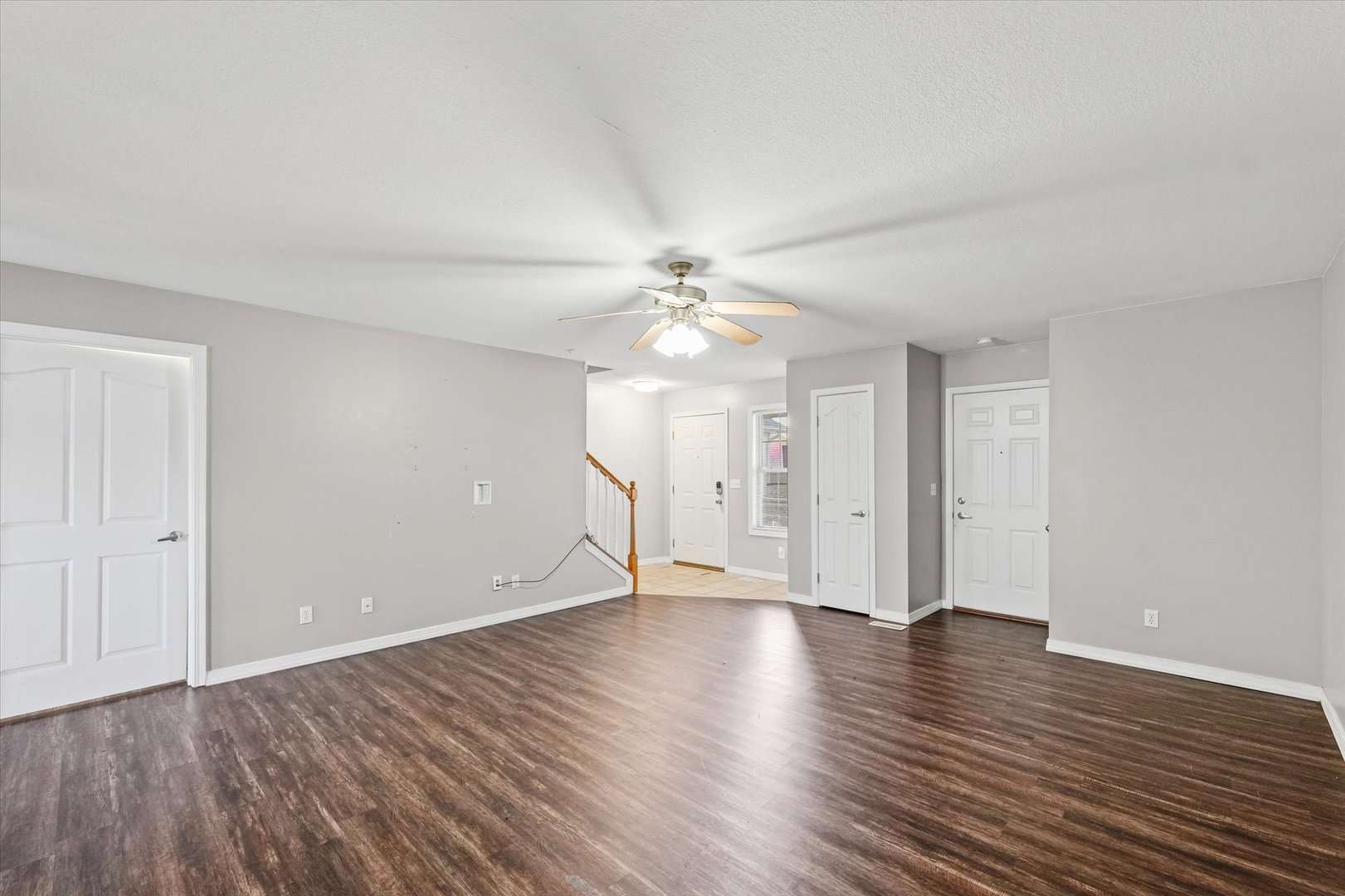 1424 Bluegrass Lane Champaign, IL 61822 - Photo 6 of 29 a view of an empty room with wooden floor and a ceiling fan