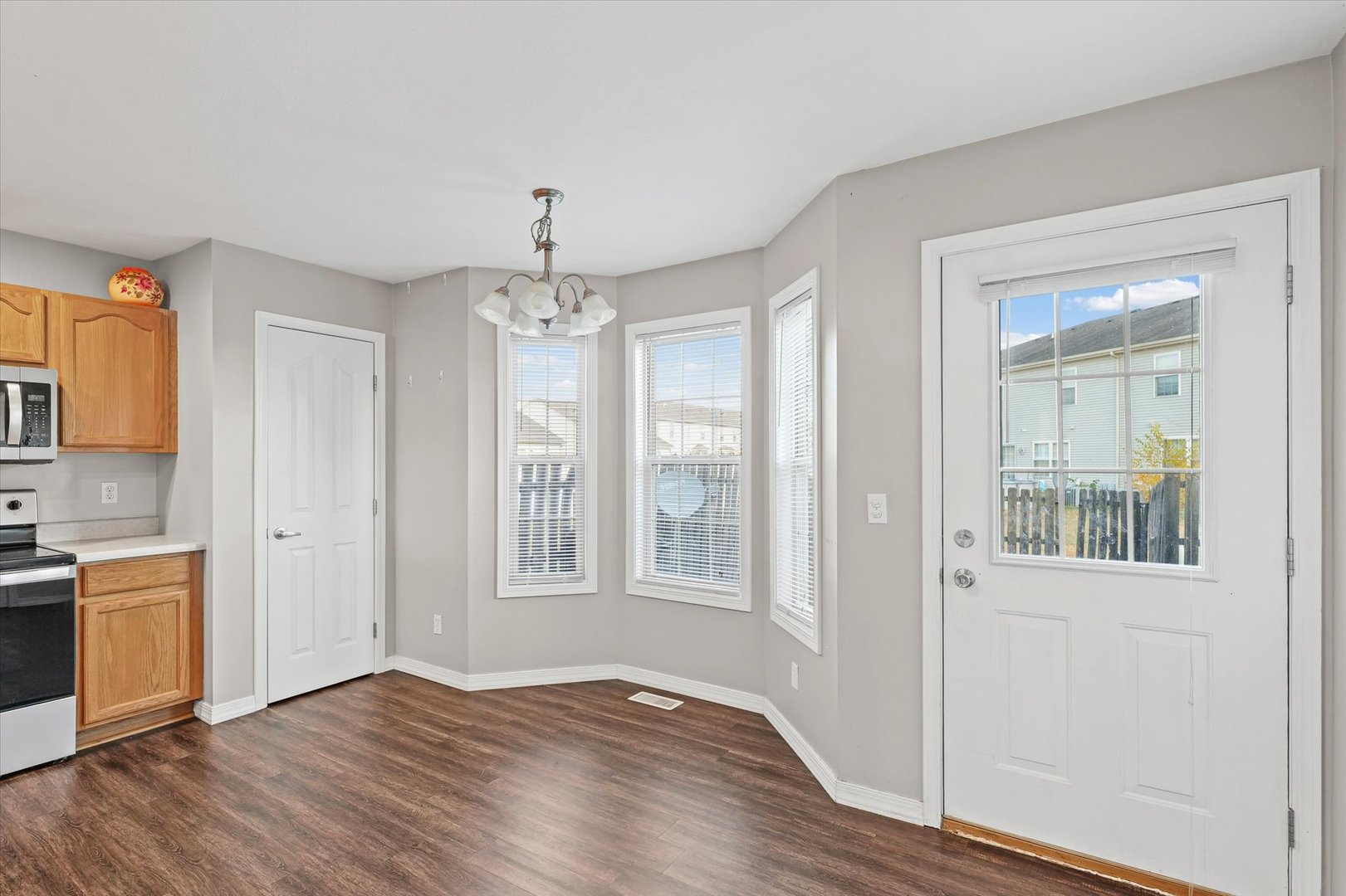 1424 Bluegrass Lane Champaign, IL 61822 - Photo 8 of 29 a view of an empty room with a window and wooden floor