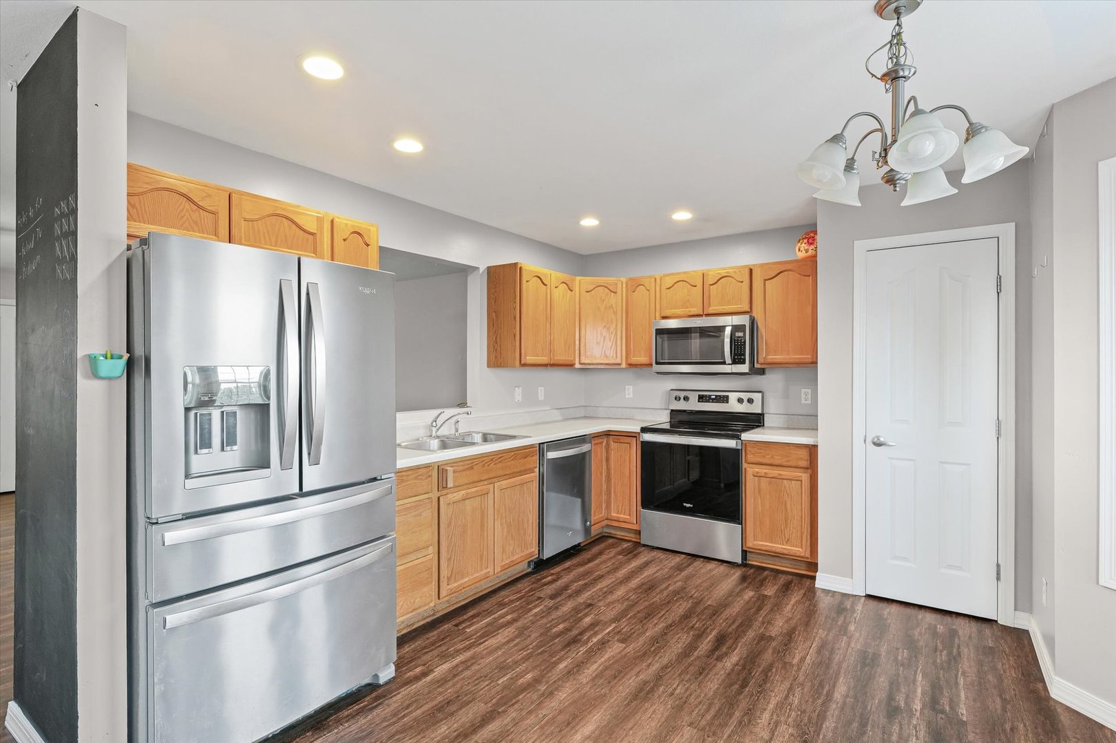 1424 Bluegrass Lane Champaign, IL 61822 - Photo 9 of 29 a kitchen with stainless steel appliances granite countertop a refrigerator a stove top oven a sink and dishwasher with wooden floor
