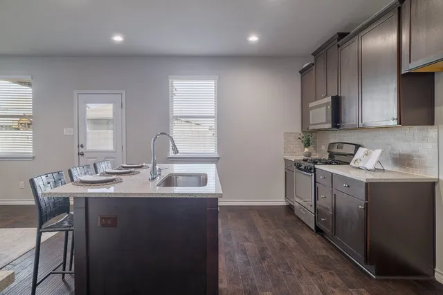 a kitchen with a sink and a refrigerator