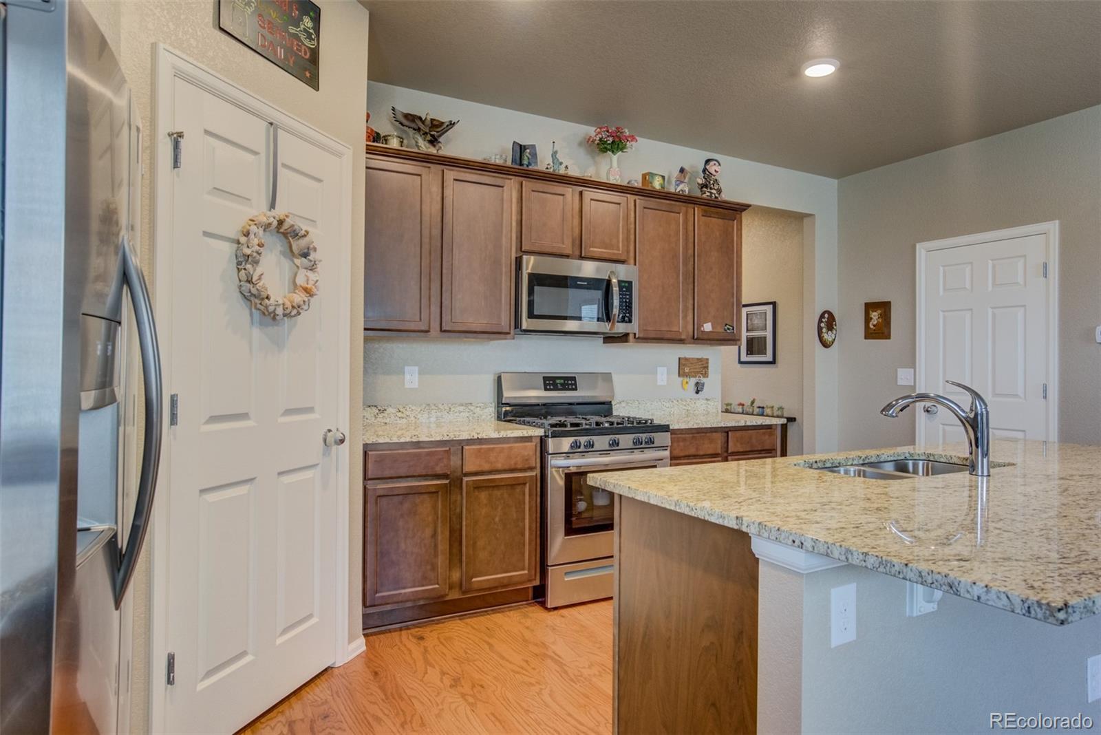 5907 Point Rider Circle Castle Rock, CO 80104 - Photo 11 of 29 a kitchen with stainless steel appliances granite countertop a sink stove and refrigerator