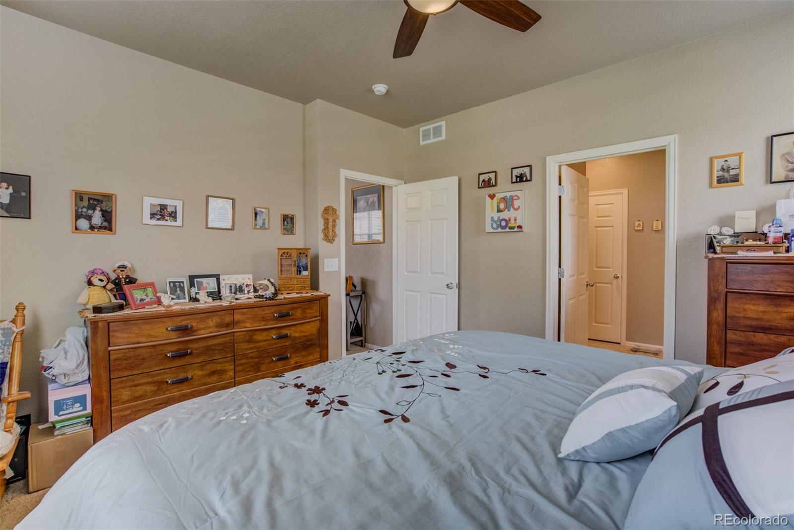 5907 Point Rider Circle Castle Rock, CO 80104 - Photo 14 of 29 a bedroom with a bed and a dresser
