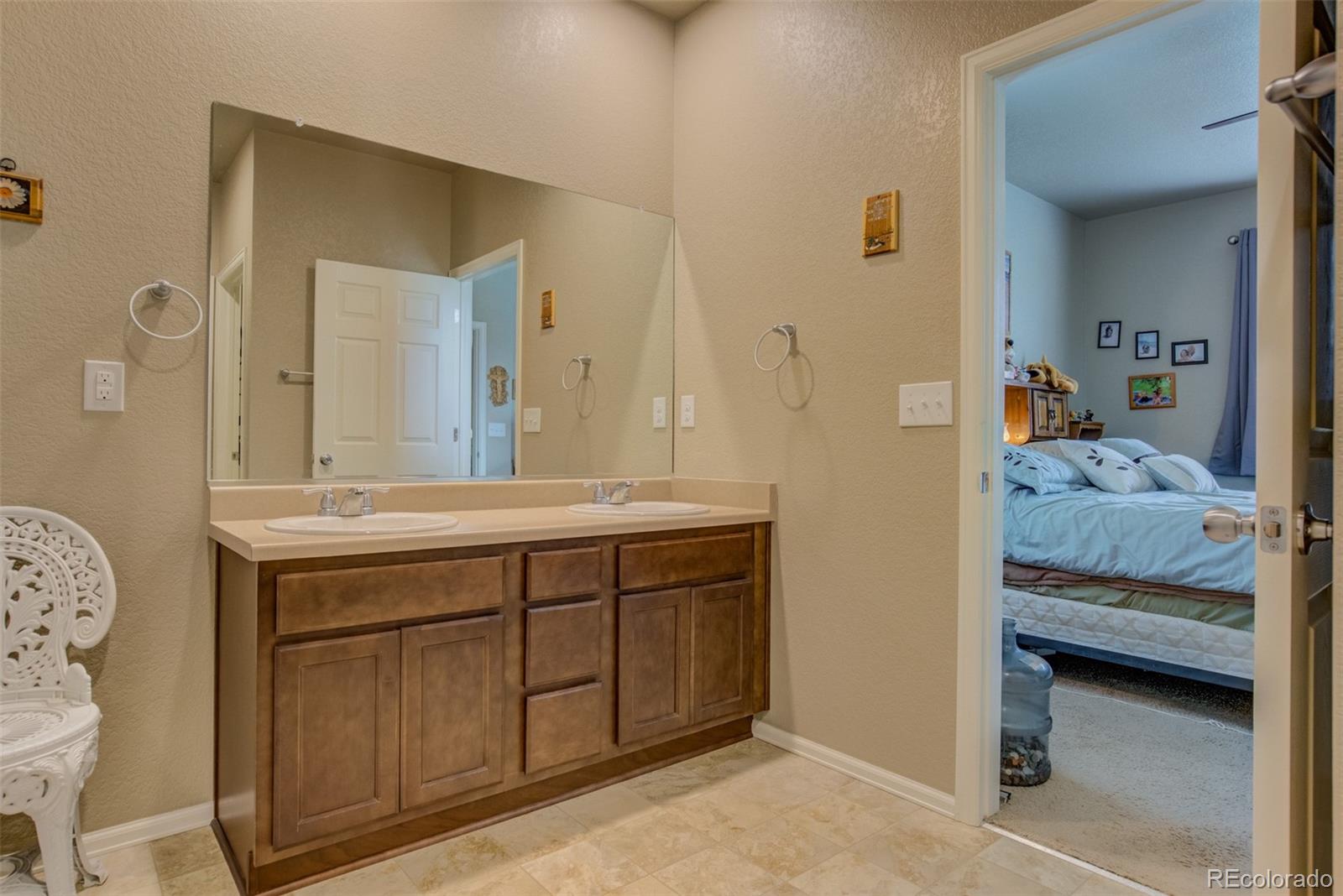 5907 Point Rider Circle Castle Rock, CO 80104 - Photo 17 of 29 a bathroom with a sink and a mirror