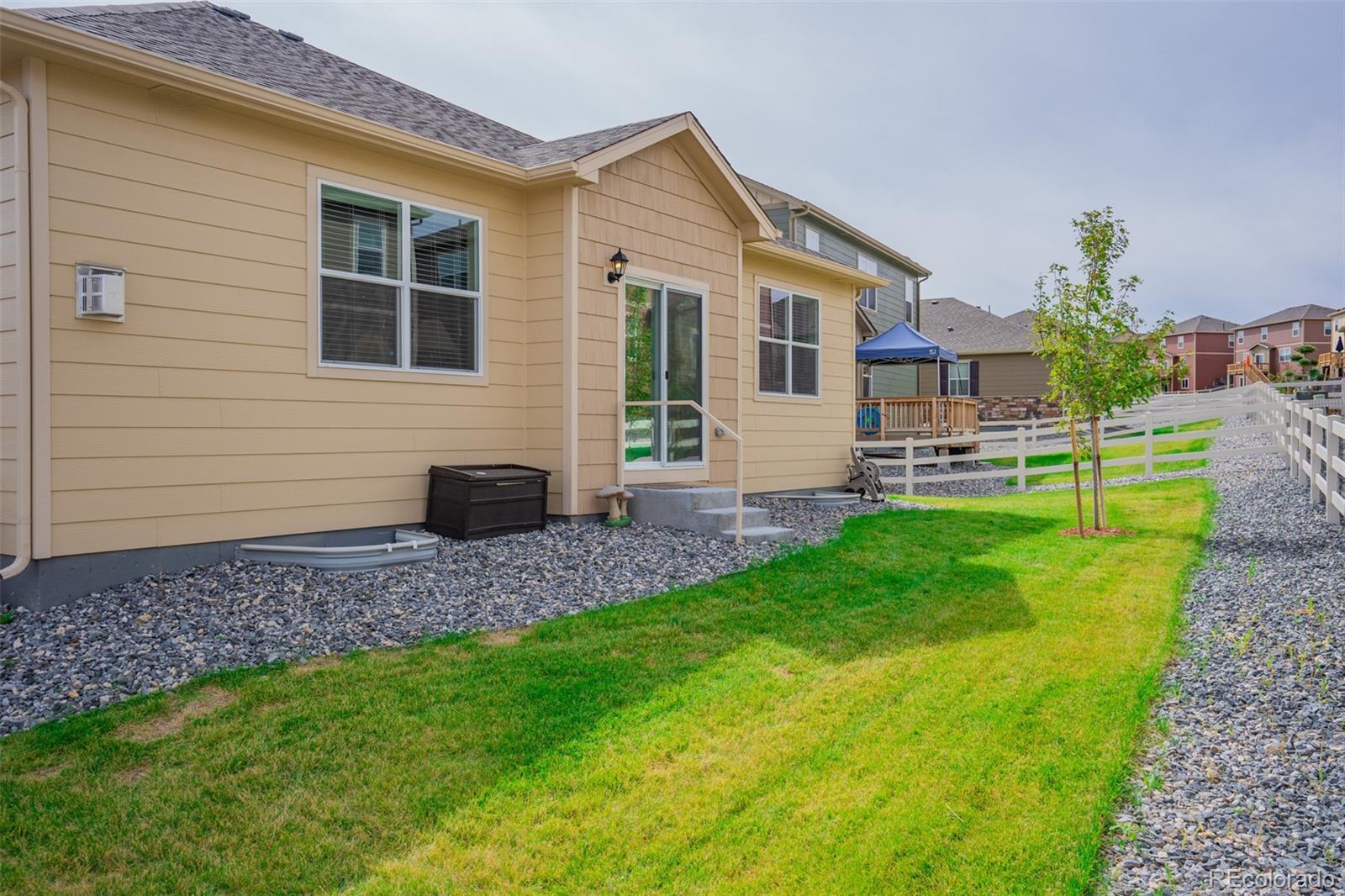 5907 Point Rider Circle Castle Rock, CO 80104 - Photo 28 of 29 a view of a house with a backyard and a porch
