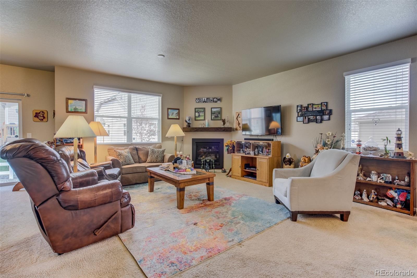 5907 Point Rider Circle Castle Rock, CO 80104 - Photo 5 of 29 a living room with furniture and a fireplace